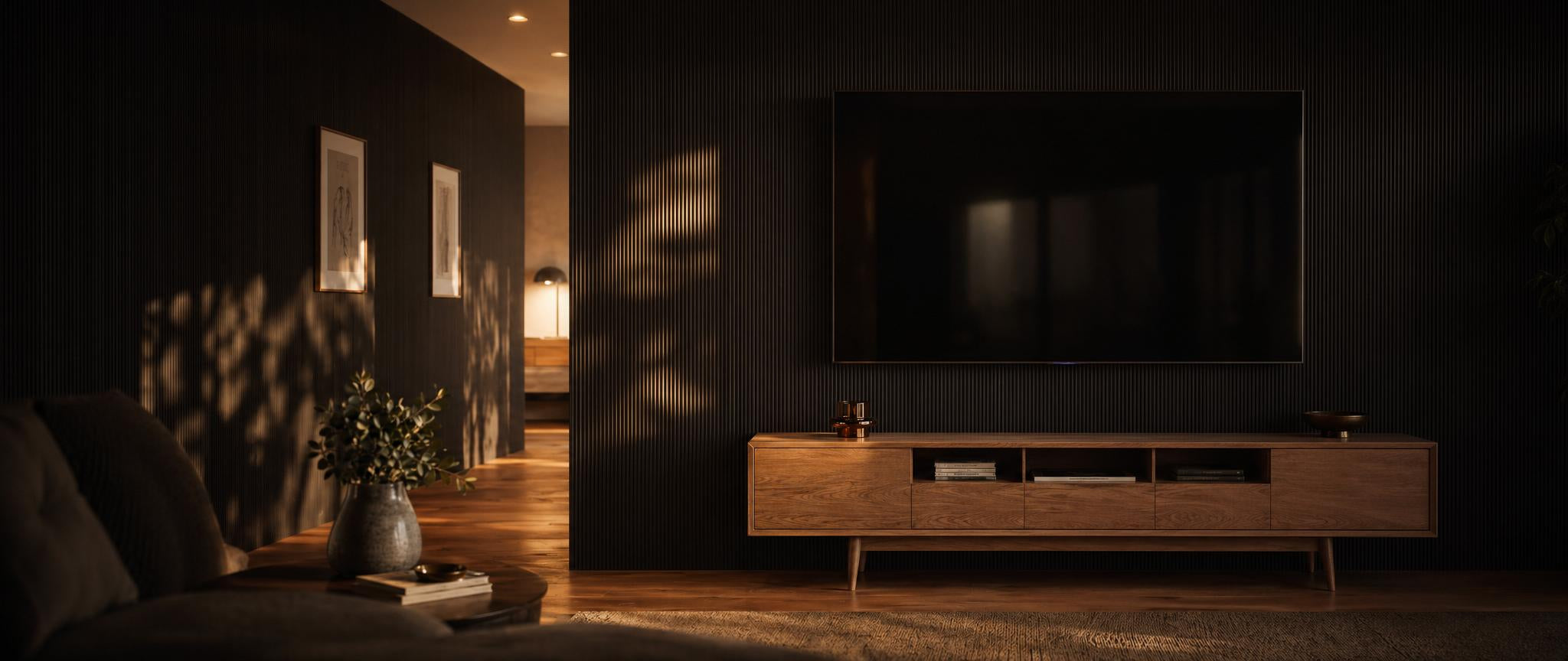Wood wall panels framing a wall-mounted TV with acoustic slat backdrop