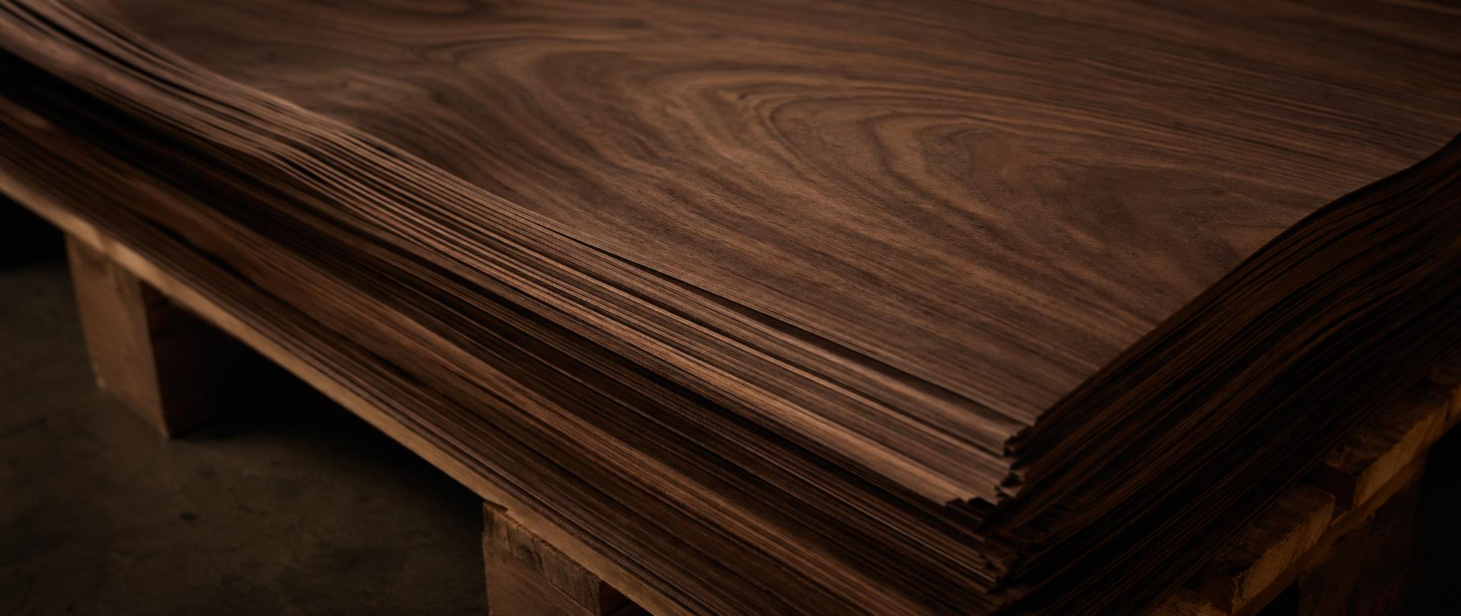Real wood veneer sheets in oak, walnut, and exotic species displayed flat