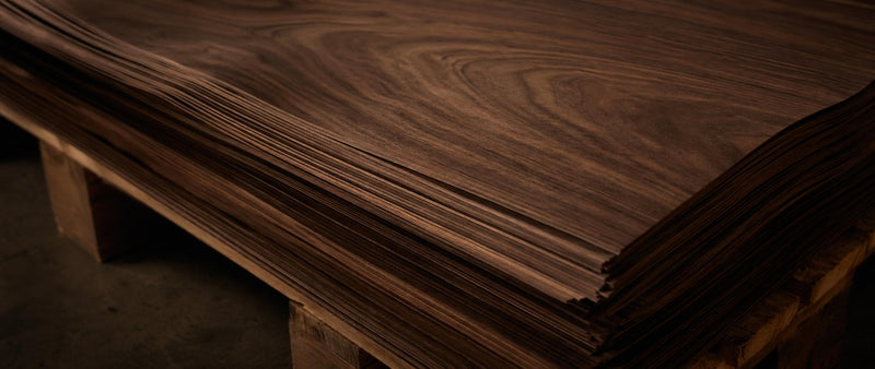 American walnut wood veneer sheets with dark figured grain displayed flat